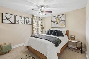 Aberdeen townhouse for rent - A bedroom with a large bed and a ceiling fan.