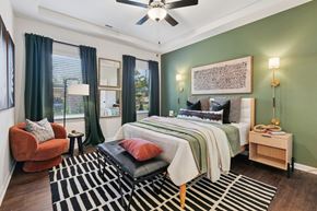 Charlotte townhouse for rent - A bedroom with a bed, chair, and rug.