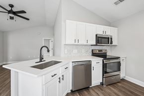 Aberdeen townhouse for rent - A modern kitchen with white cabinets and stainless steel appliances.
