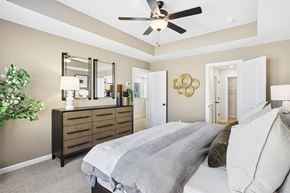Braselton apartment for rent - A bedroom with a large bed and a ceiling fan.