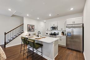 Charlotte townhouse for rent - A kitchen with a white counter top and a stainless steel refrigerator.