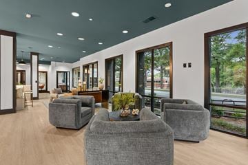 Atlanta apartment for rent - A modern living room with grey couches and a wooden coffee table.