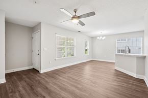 Aberdeen townhouse for rent - A room with a ceiling fan and wooden flooring.