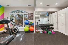 Concord apartment for rent - A gym room with a treadmill, exercise balls, and weights.