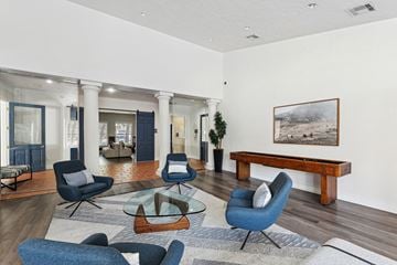 Austin apartment for rent - A living room with blue chairs and a wooden bench.