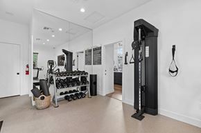 Rocklin apartment for rent - A gym room with a weight rack and a mirror.