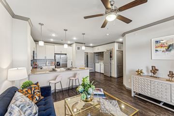 Cedar Park apartment for rent - A modern living room with a blue sofa and a glass coffee table.