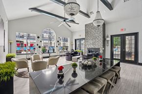 Round Rock apartment for rent - A modern dining room with a glass table and chairs.