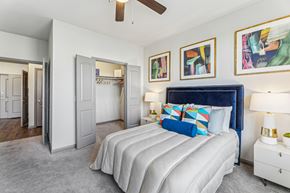 Cedar Park apartment for rent - A bedroom with a large bed and a ceiling fan.