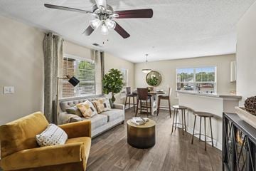 Aberdeen townhouse for rent - A living room with a yellow chair and a grey couch.