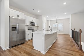Charlotte townhouse for rent - A kitchen with a refrigerator, microwave, oven, and sink.