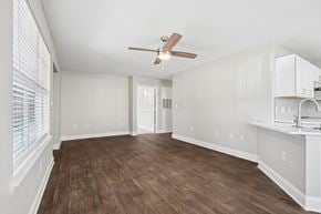 Aberdeen townhouse for rent - A room with a ceiling fan and wooden flooring.