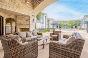 Houston apartment for rent - the preserve at ballantyne commons clubhouse patio with wicker furniture