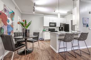 Houston apartment for rent - an open kitchen and dining area with a table and chairs