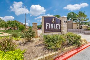 Tyler apartment for rent - a sign that says finley athletic center with a building and trees in the background