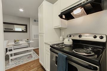 Houston apartment for rent - A white stove with a kettle on it in a kitchen.