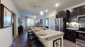 Mansfield apartment for rent - a kitchen with a large island and black cabinets