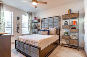 Mansfield apartment for rent - a bedroom with a bed and a bookshelf
