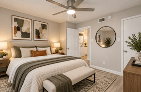 Dallas apartment for rent - A bedroom with a large bed and a ceiling fan.