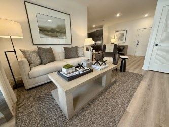 Katy apartment for rent - A living room with a white couch, a coffee table, and a painting on the wall.