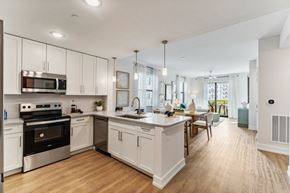 Cape Coral apartment for rent - A modern kitchen with white cabinets and stainless steel appliances.