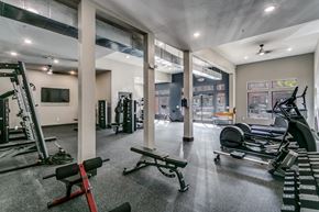Highland Village apartment for rent - a gym with weights and other exercise equipment and a tv