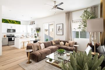 Casa Grande apartment for rent - A modern living room with a brown couch and a glass coffee table.