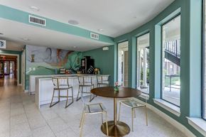 New Braunfels apartment for rent - a room with a table and chairs in front of a window with a mural on the wall