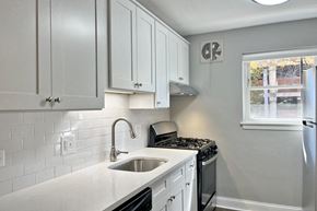 Oak Park apartment for rent - a kitchen with white cabinets and a sink and a window