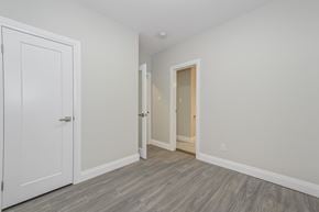 Kitchener apartment for rent - A room with a white door and a grey floor.