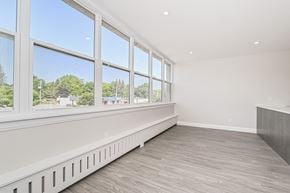 Kitchener apartment for rent - A room with a long window wall and a wood floor.