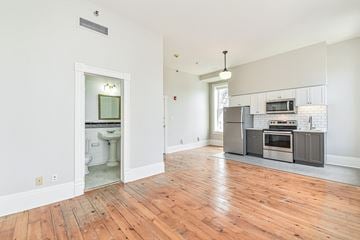 Waterloo apartment for rent - A kitchen with a stove top oven and microwave.