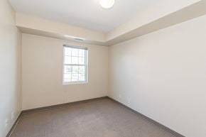 Waterloo apartment for rent - A room with a window and carpeted floor.