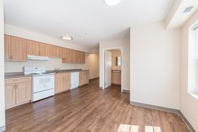 Waterloo apartment for rent - A kitchen with wooden floors and white appliances.