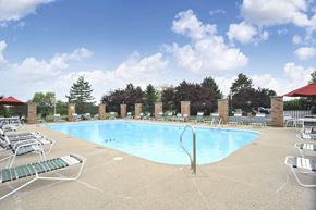 Valparaiso apartment for rent - Swimming pool at Golfview Apartments surrounded by lounge chairs and trees.