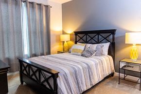 Valparaiso apartment for rent - A bedroom with a bed, nightstand, and lamp.