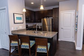 Valparaiso apartment for rent - A kitchen with a granite countertop and a stainless steel refrigerator.