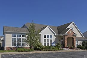 Merrillville apartment for rent - A large house with a brick pillar entrance.