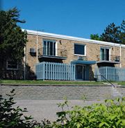 St Paul apartment for rent - a brick building with a white fence in front of it