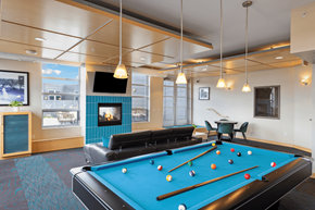 St Paul apartment for rent - a games room with a pool table and a fireplace