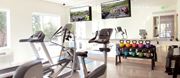 Minneapolis apartment for rent - Coze Flats fitness center with a treadmill, elliptical, spin bike, free weights and kettle bells