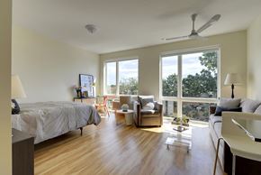 Minneapolis apartment for rent - Flat B studio apartment floor plan, hardwood floors and oversized windows. Model apartment with queen sized bed, desk and living area