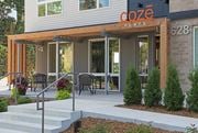 St Paul apartment for rent - the entrance to coze flats with tables and chairs outside of the building