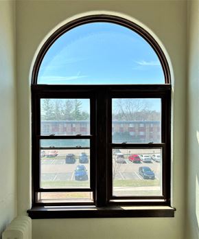 St Paul apartment for rent - an arched window with a view of a parking lot