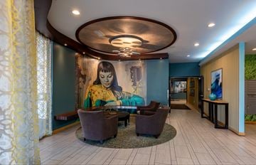 Minneapolis apartment for rent - A living room with a large painting on the wall and a circular ceiling light.