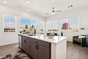 Las Vegas apartment for rent - A kitchen with a large island and a view of the city. at Lura Vegas Apartments, Nevada, 89103