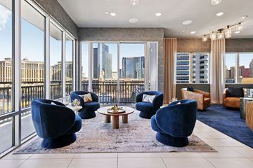 Las Vegas apartment for rent - A living room with blue chairs and a view of the city.