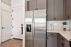 Las Vegas apartment for rent - A stainless steel refrigerator in a kitchen with white cabinets. at Lura Vegas Apartments, Nevada, 89103