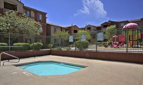 Las Vegas apartment for rent - A small pool in a fenced in area with a slide.