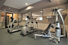 Henderson apartment for rent - A gym with a mirror, treadmill, and exercise bike.